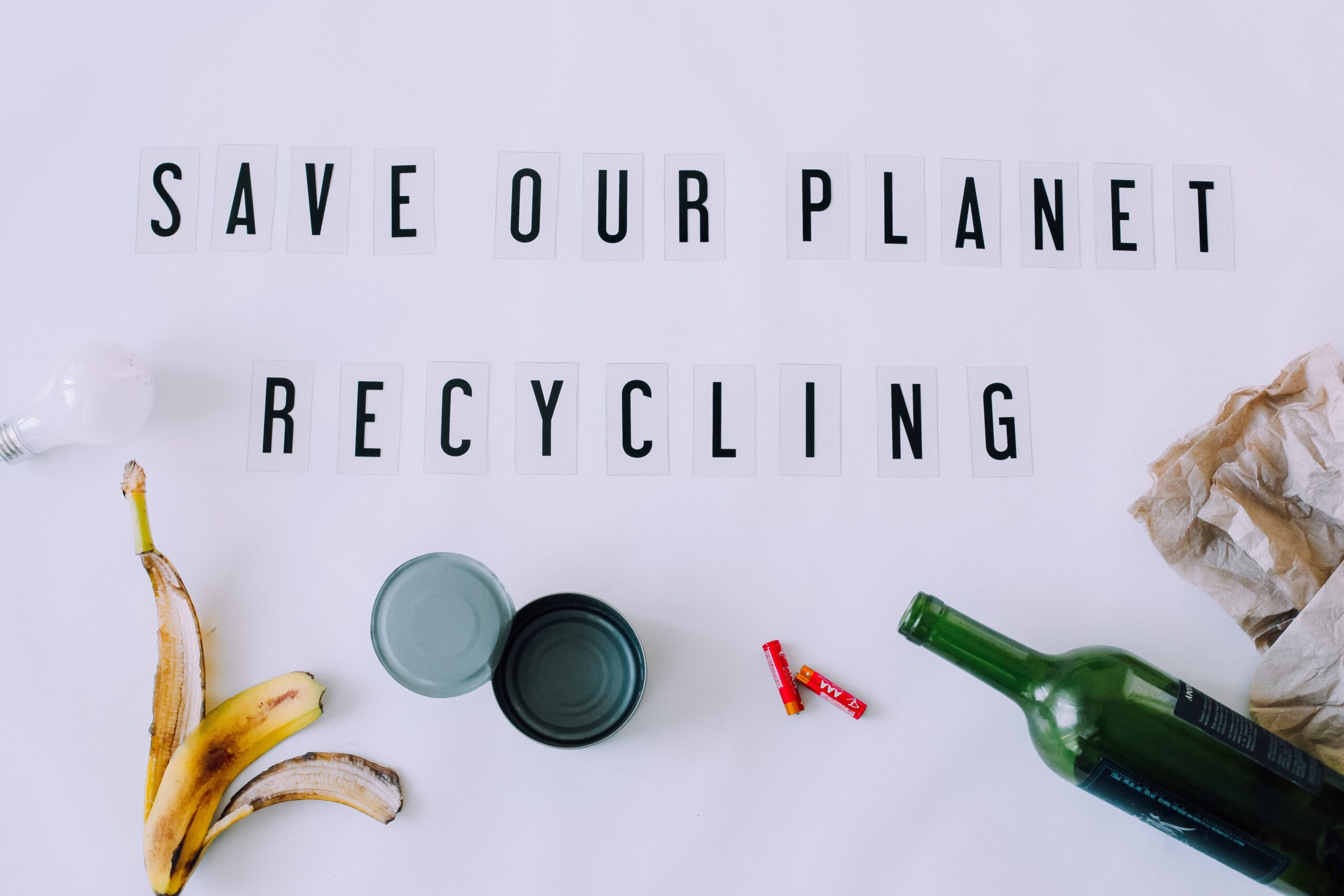 Save our planet and recycle text on white background with recyclable items